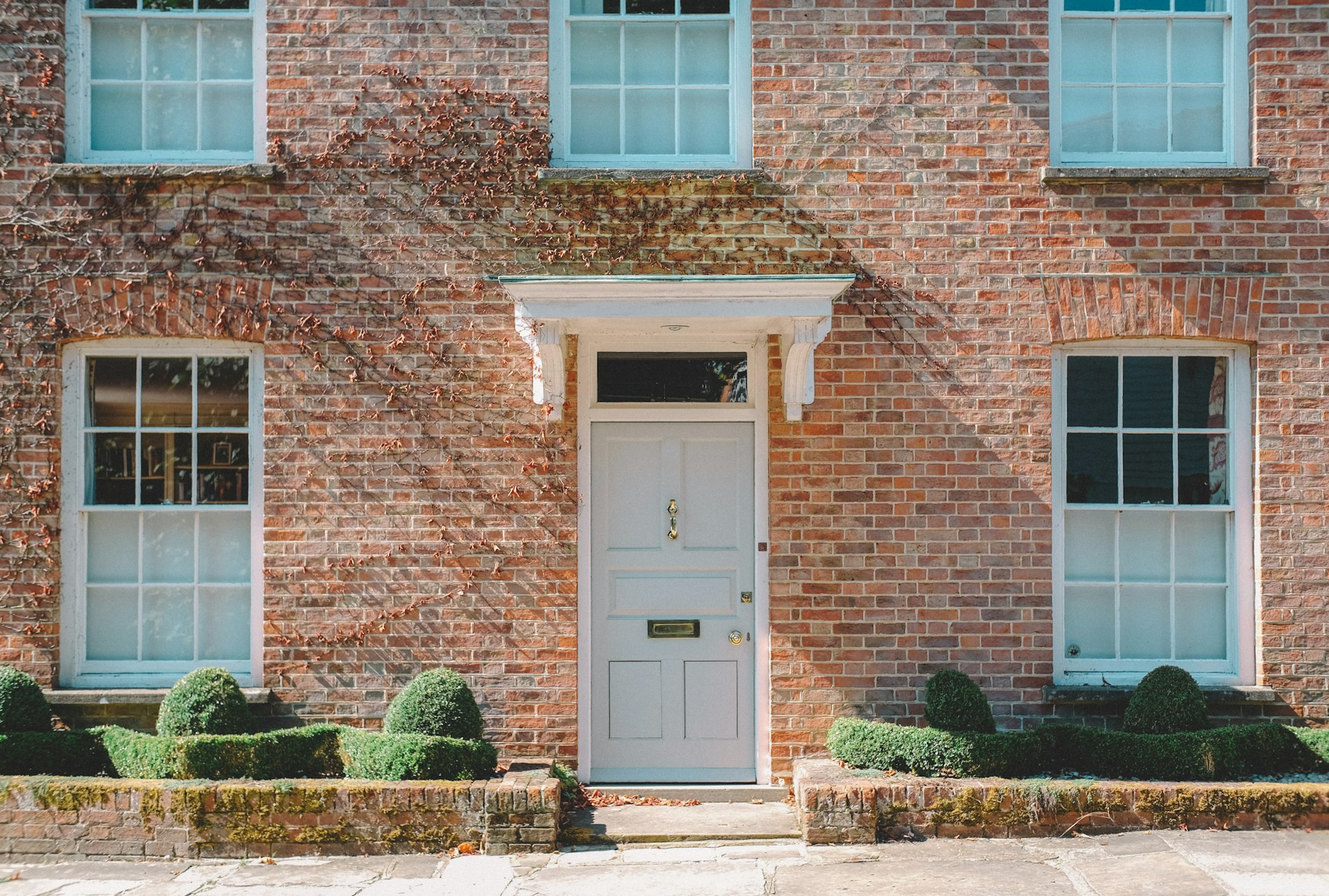 Period brick frontage with sash windows and a canopy porch