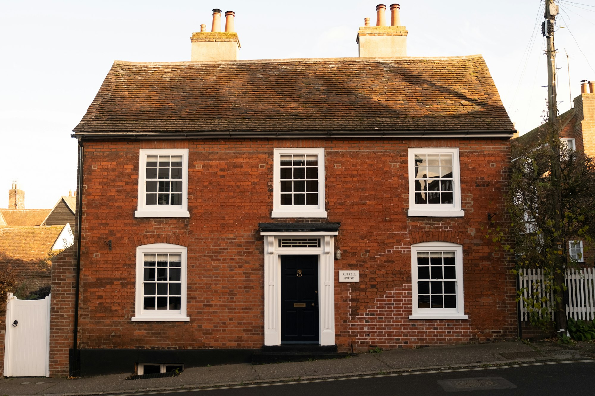 Red brick house with white sash windows and a clean, well-pointed front elevation