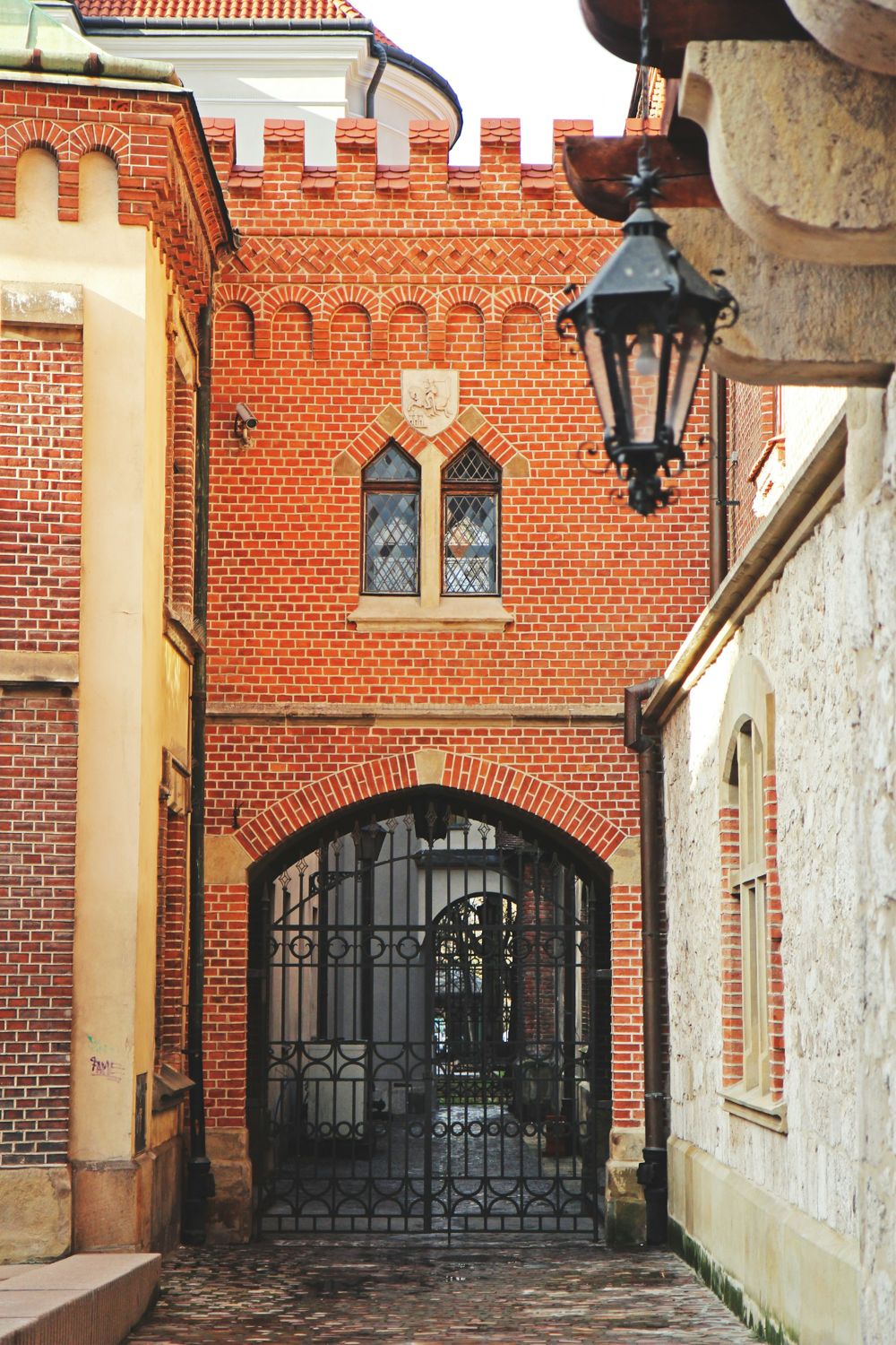 Brick archway with stone dressings above a gate
